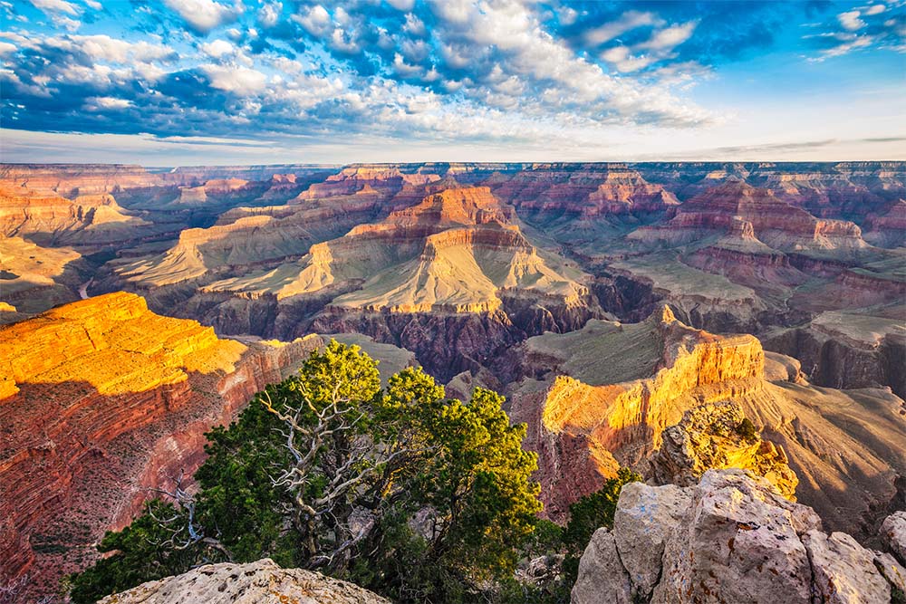 Arizona - Red and tan canyon lands with a river running through, which has carved out a deep pathway over time.