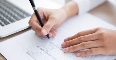 Closeup business person completing form
